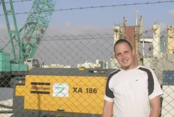Cas next to an Atlas Copco XA 186 portable compressor